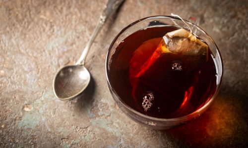 Steeping tea bag in a glass cup